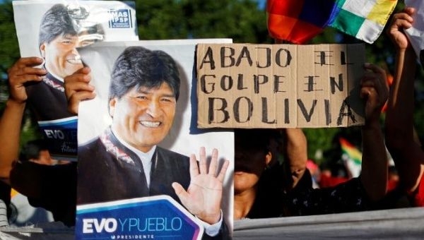 Supporters of Bolivia's ousted President Evo Morales hold a placard that reads "Down with the coup in Bolivia" as they gather outside the U.S. embassy in Buenos Aires to protest against the U.S. government, in Buenos Aires, Argentina November 22, 2019