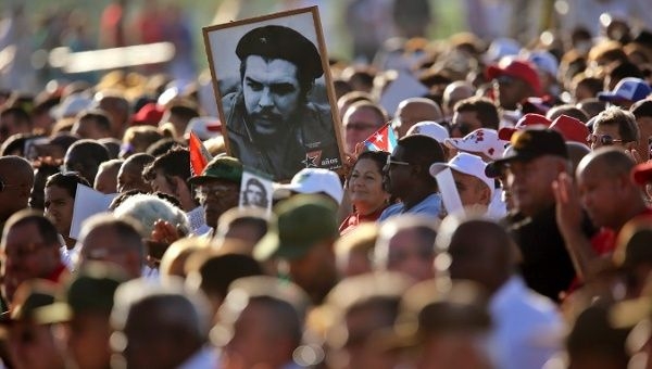 People in Cuba carry a portrait of Che during an act to commemorate the 50th anniversary of his death. 